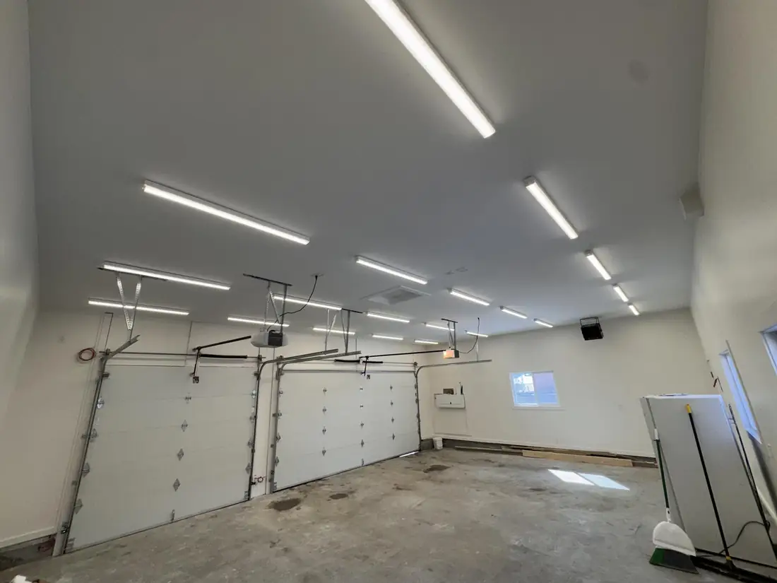 Large new garage with rows of linear LED fixtures across the ceiling